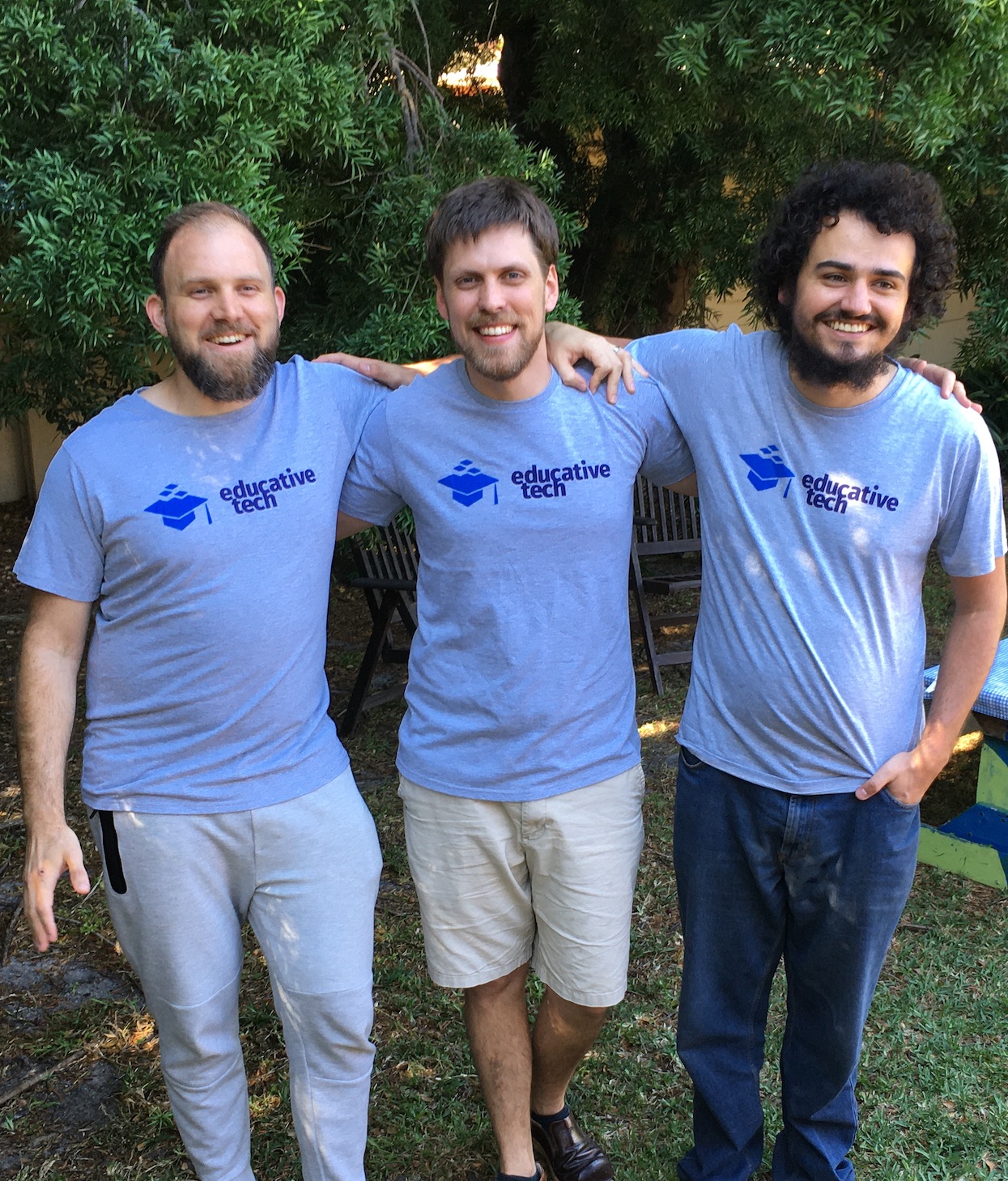 Image of the Educative tech team together smiling outdoors wearing branded t-shirts